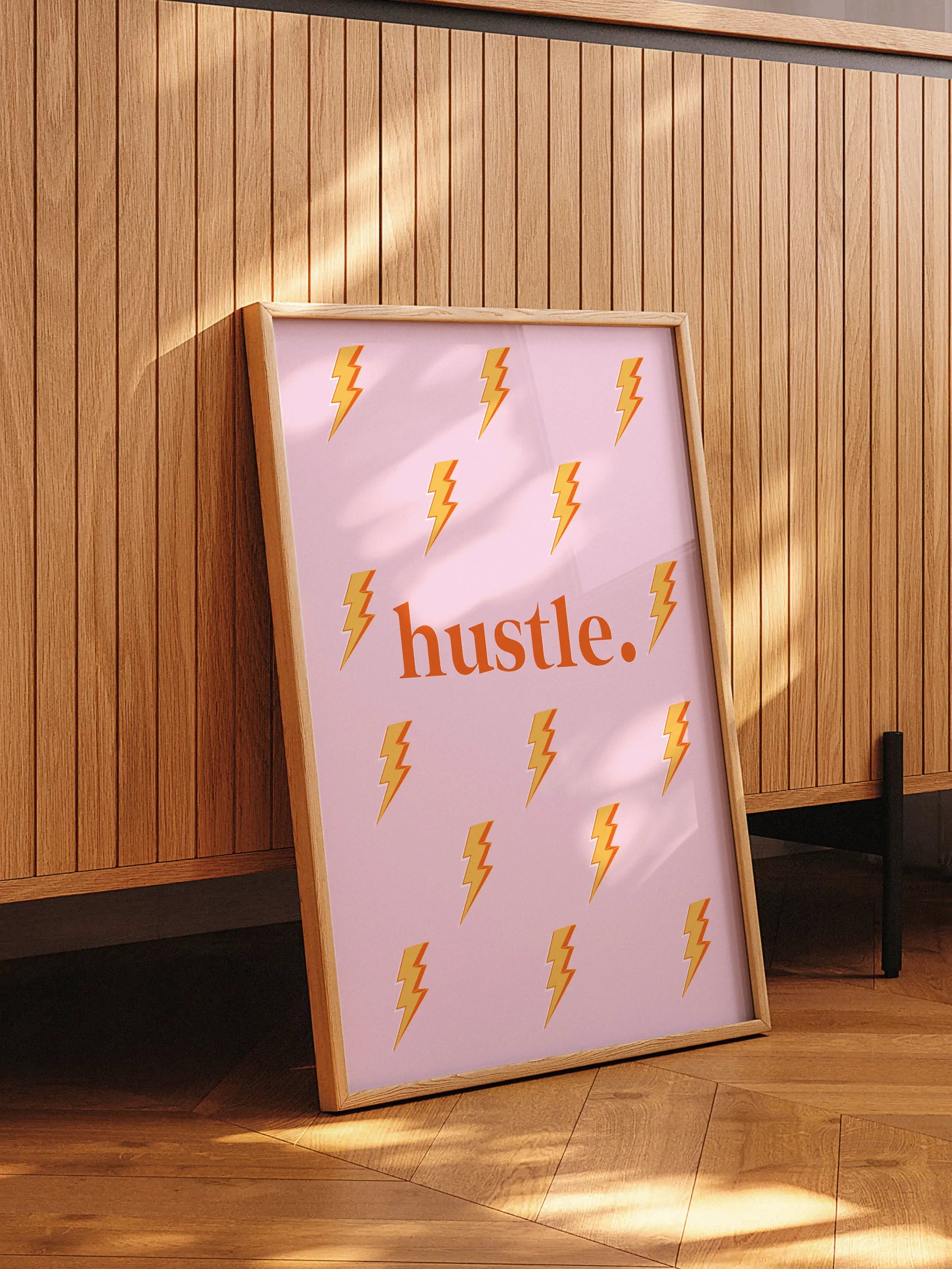Pink motivational poster with 'Hustle.' text and lightning bolt pattern.